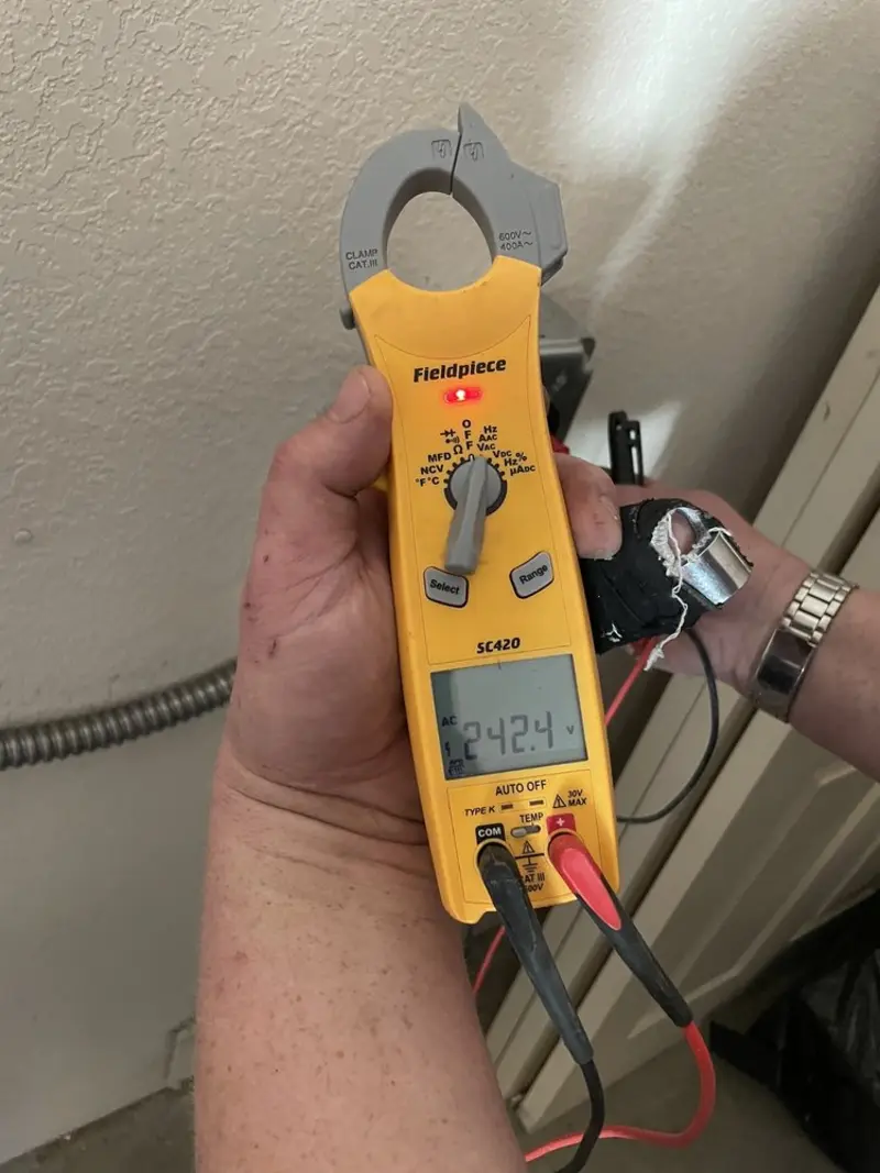 Voltage testing with clamp meter during Outlet Installation in East Camden
